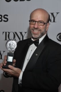 Larry Hirschhorn holding his Tony Award, 2013